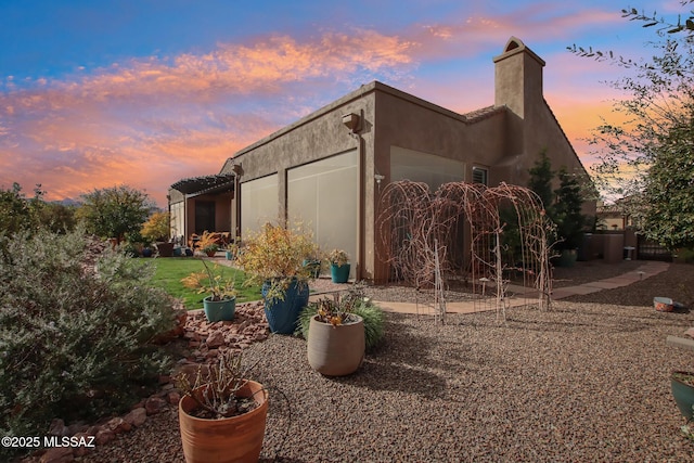36239 S Cypress Dr, Saddlebrooke, AZ 85739 - view of side of home with a garage and stucco siding