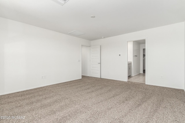 unfurnished room featuring light colored carpet