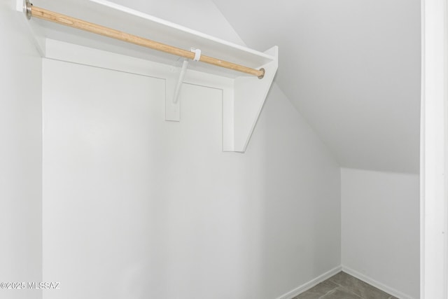 walk in closet featuring vaulted ceiling