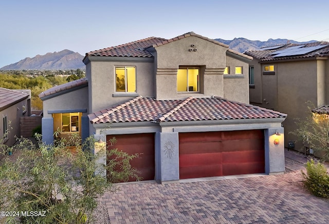 mediterranean / spanish-style home with a garage and a mountain view