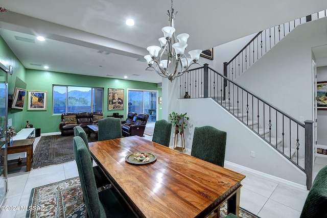 dining area featuring light tile patterned floors and a notable chandelier