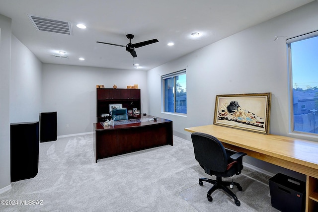 carpeted office featuring ceiling fan