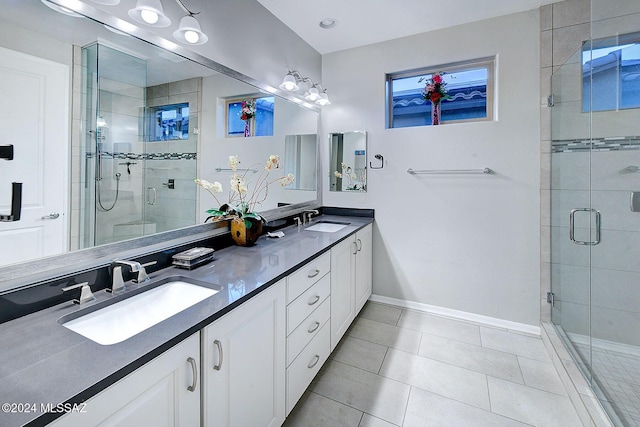 bathroom with vanity, an enclosed shower, and tile patterned floors