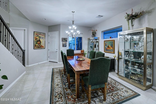 dining room with an inviting chandelier and light tile patterned floors