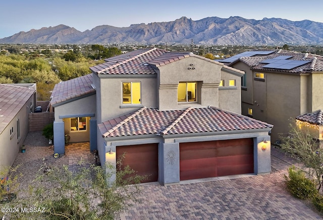 mediterranean / spanish-style home featuring a garage and a mountain view