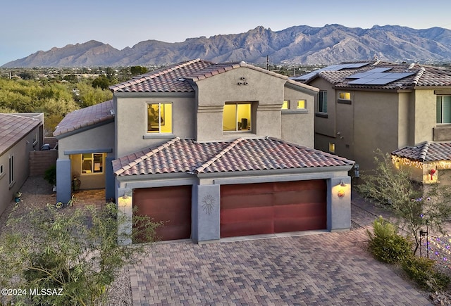 mediterranean / spanish-style house with a garage and a mountain view