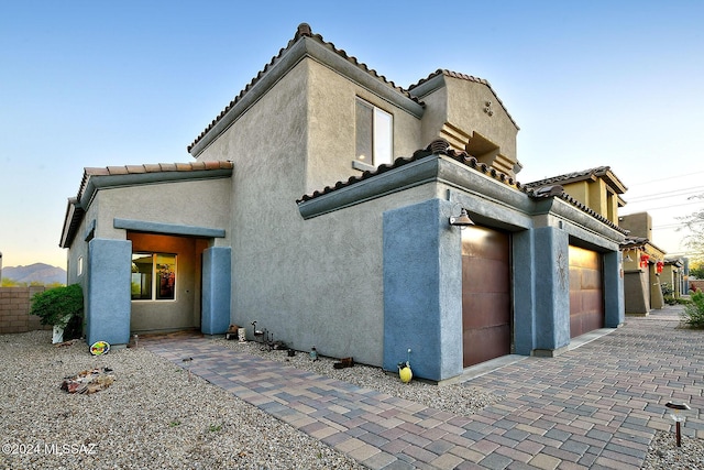 property exterior at dusk with a garage