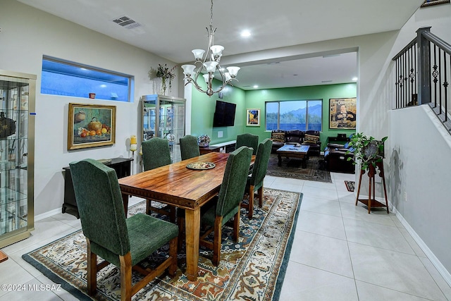 dining room featuring an inviting chandelier and light tile patterned floors