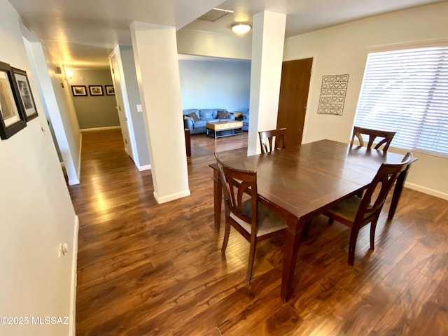 dining space with dark wood-type flooring