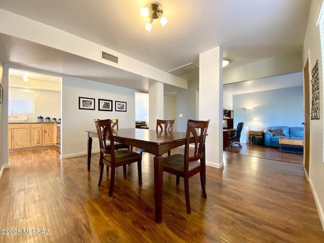 dining space featuring dark hardwood / wood-style floors