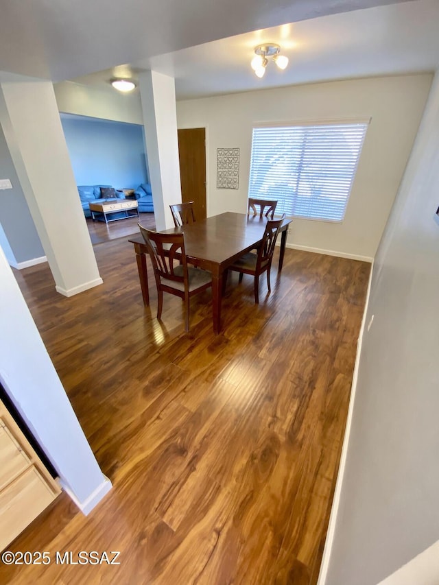 dining room with dark wood-type flooring