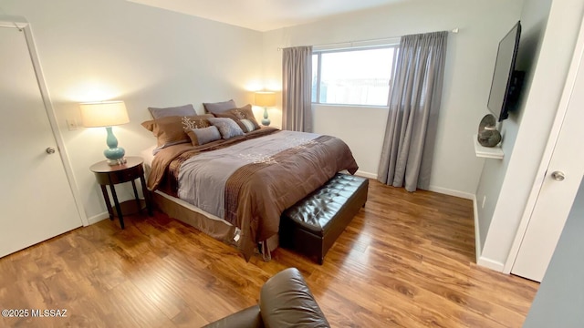 bedroom with wood-type flooring