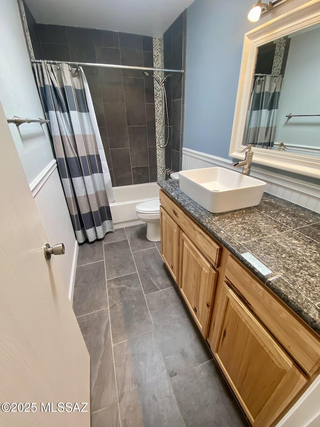 full bathroom with vanity, shower / bath combo, and toilet