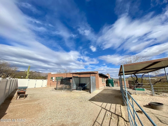 back of property featuring an outbuilding and a mountain view