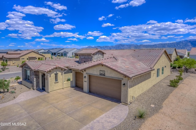 view of front of house with a garage and a mountain view