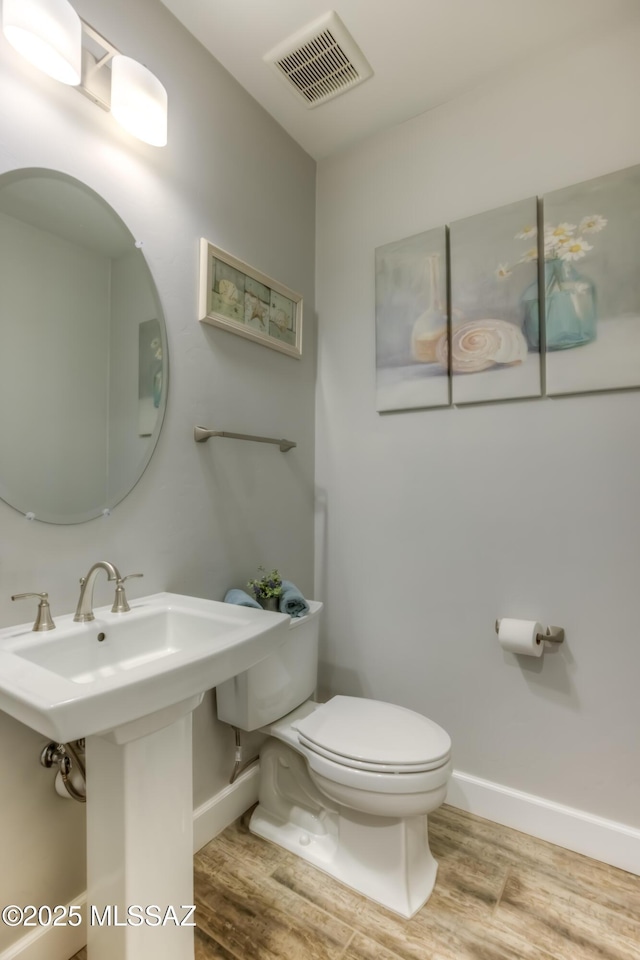 bathroom featuring hardwood / wood-style floors, sink, and toilet