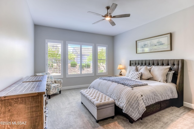 bedroom with ceiling fan, multiple windows, and light carpet