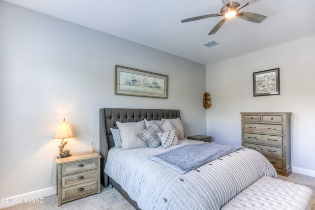 bedroom with ceiling fan and light carpet