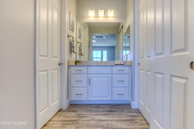 bathroom featuring wood-type flooring and vanity