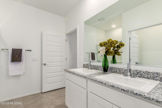 bathroom with tile patterned floors and vanity