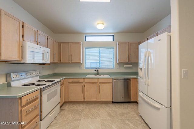 kitchen featuring sink, light brown cabinets, and white appliances