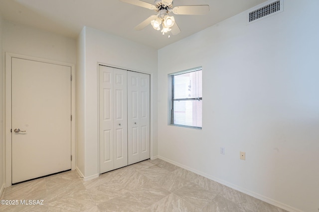 unfurnished bedroom featuring a closet and ceiling fan