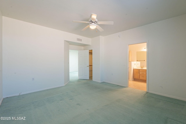 spare room with light carpet and ceiling fan