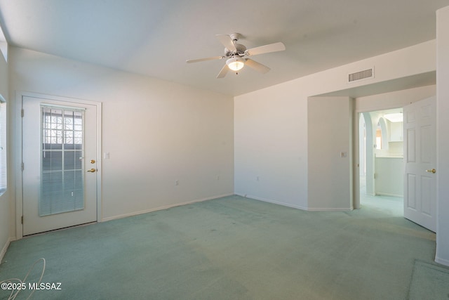 carpeted spare room with ceiling fan