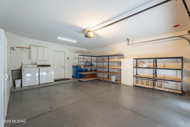 garage with a garage door opener and washer and clothes dryer