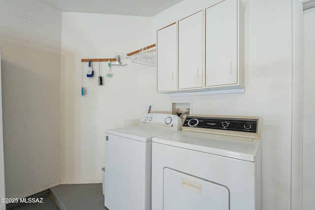 laundry area featuring cabinets and washing machine and dryer