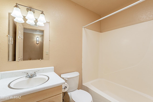 full bathroom featuring vanity, bathtub / shower combination, and toilet