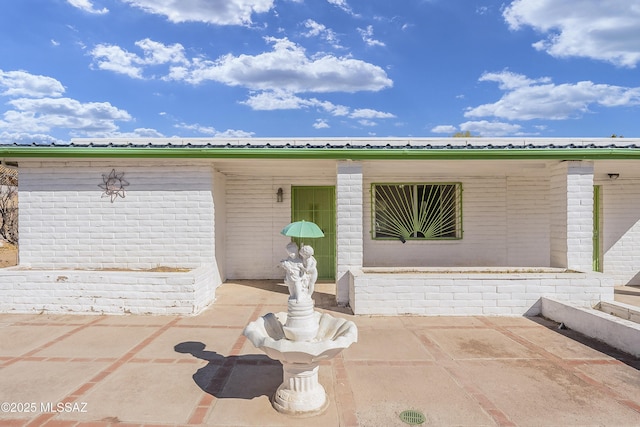 doorway to property featuring a patio area