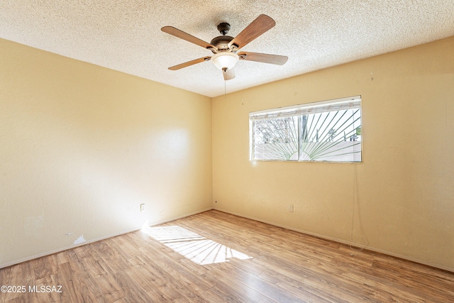 unfurnished room with ceiling fan, a textured ceiling, and light hardwood / wood-style flooring