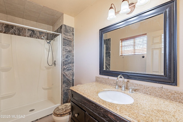 bathroom with vanity, toilet, and a shower