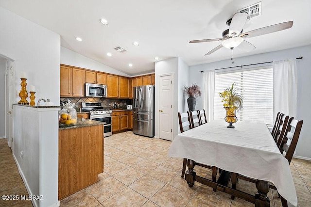 kitchen with brown cabinets, ceiling fan, visible vents, backsplash, and appliances with stainless steel finishes
