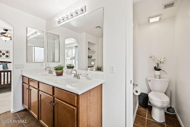 bathroom with a sink, baseboards, and visible vents
