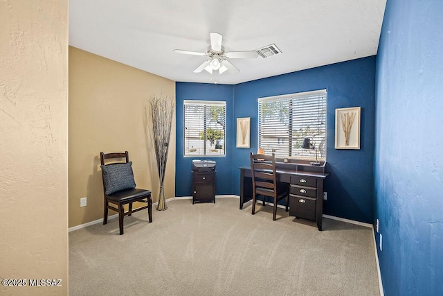 carpeted office with baseboards, visible vents, and ceiling fan