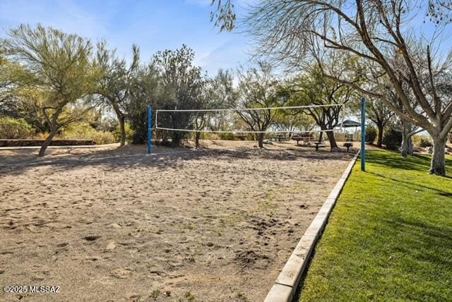 surrounding community with volleyball court and a yard