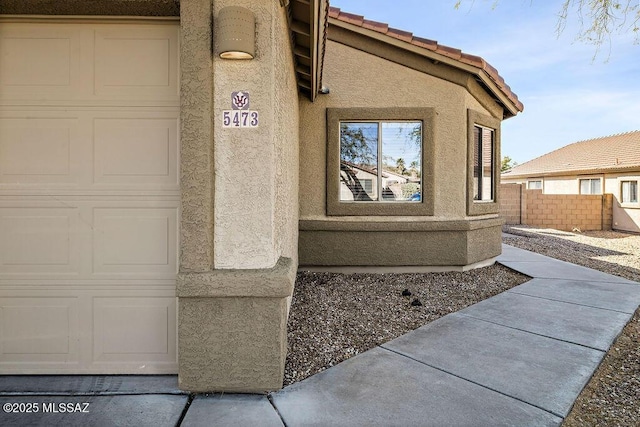 5473 W Bandtail Ct, Marana, AZ 85658 - view of side of property with stucco siding, fence, and a tile roof