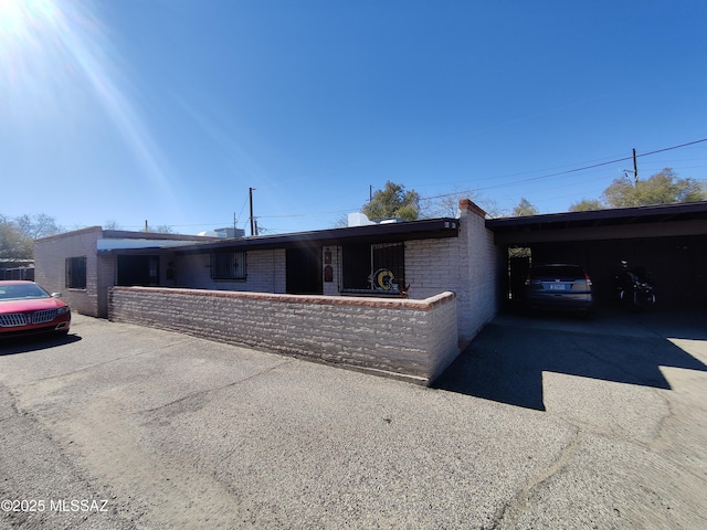 single story home featuring a carport