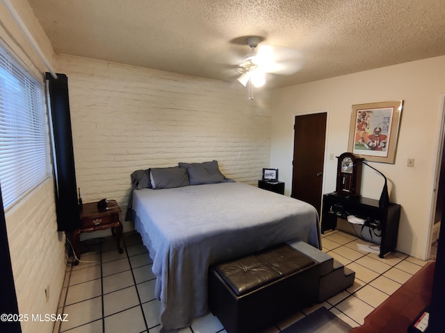 4016 E Fairmount St, Tucson, AZ 85712 - bedroom featuring light tile patterned flooring, a ceiling fan, brick wall, and a textured ceiling