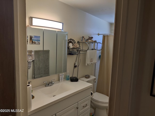 bathroom featuring vanity, toilet, and a shower with shower curtain