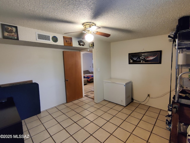 4016 E Fairmount St, Tucson, AZ 85712 - interior space with a textured ceiling, ceiling fan, visible vents, and light tile patterned floors