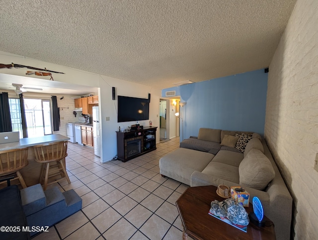 4016 E Fairmount St, Tucson, AZ 85712 - living room with light tile patterned flooring, a textured ceiling, and visible vents