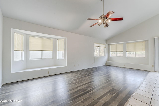 spare room featuring wood-type flooring, ceiling fan, and vaulted ceiling