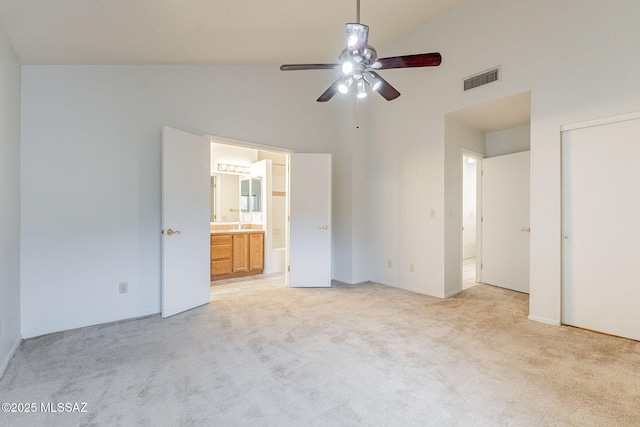 unfurnished bedroom with light carpet, connected bathroom, high vaulted ceiling, and ceiling fan