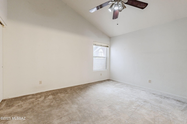 carpeted empty room with ceiling fan and high vaulted ceiling