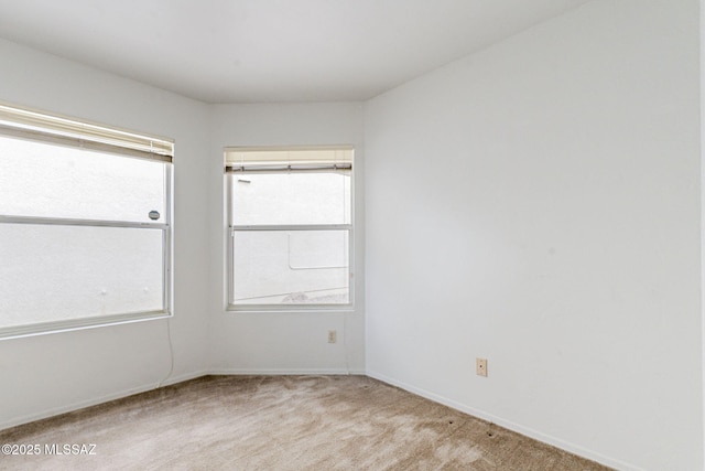 unfurnished room with light colored carpet