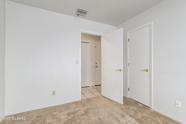 unfurnished bedroom with light carpet