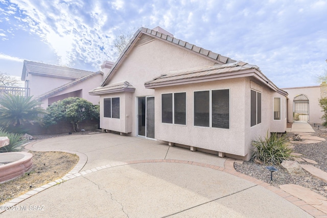 back of property with a patio